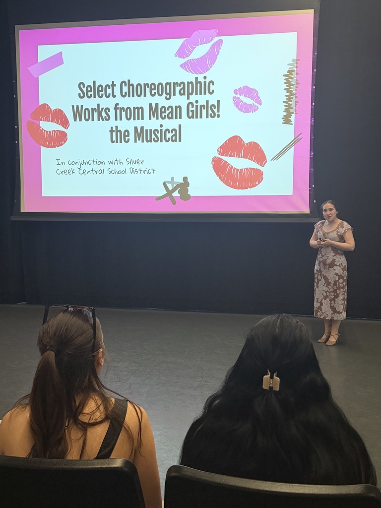 Ms. Jasinski on stage in front of projection screen