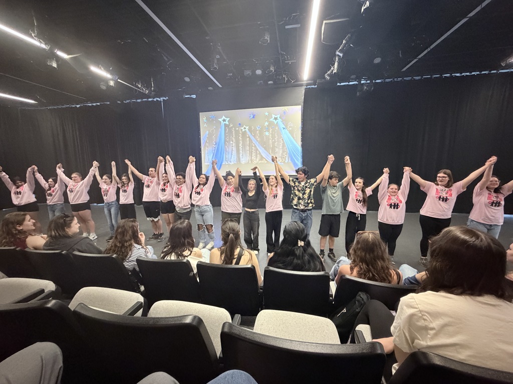 Student cast taking a bow on stage