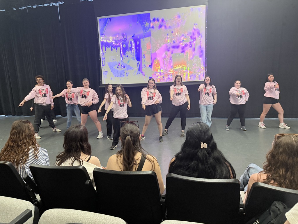 students performing dances on stage