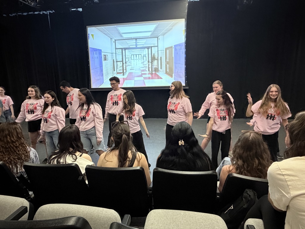 students performing dances on stage