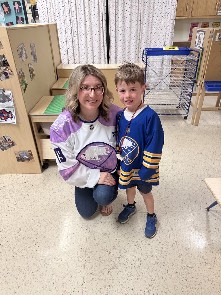 Mrs. Radoani and male student wearing Sabres jerseys