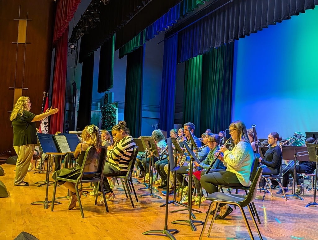 Ms. Bachowski directs 4th grade band on stage