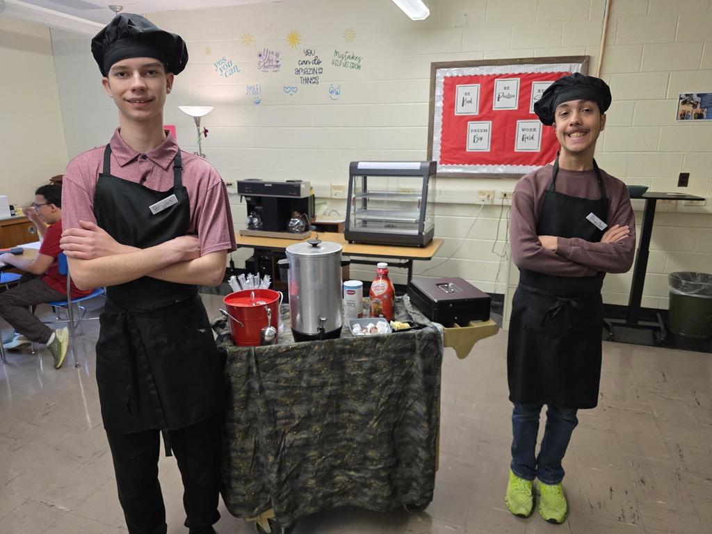 Bryan and Preston in chef hats and aprons