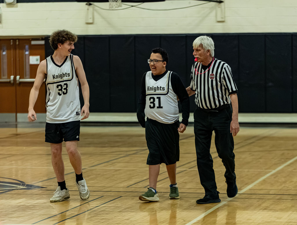 two SC players smile with a Ref