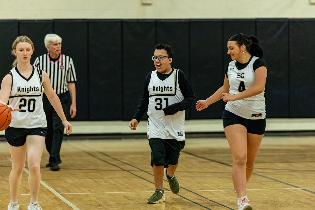 Three SC players dribble the ball downcourt