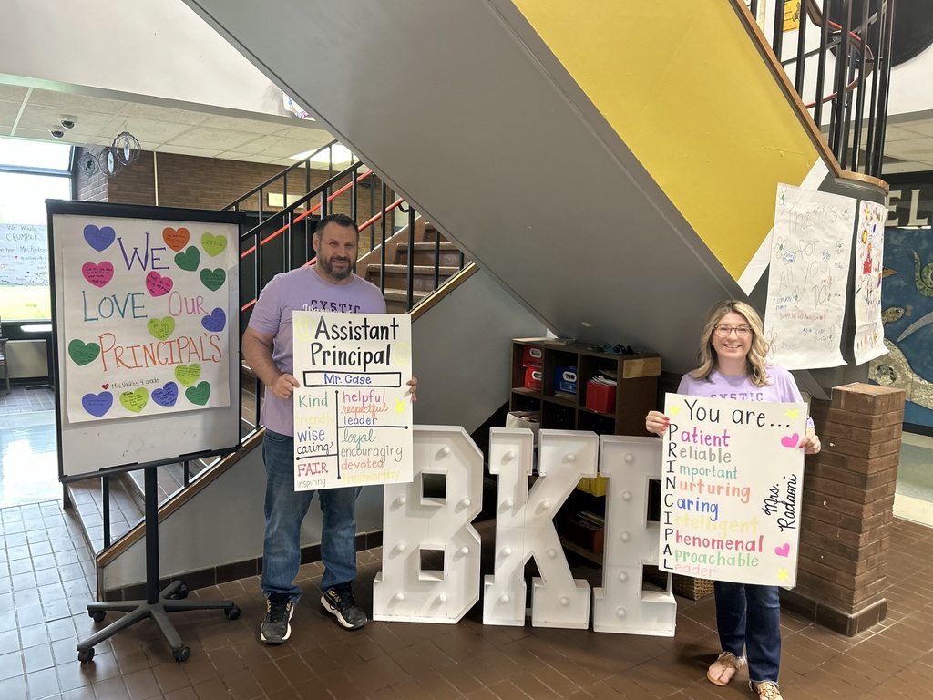 Mr. Case and Mr. Radoani in the lobby with posters