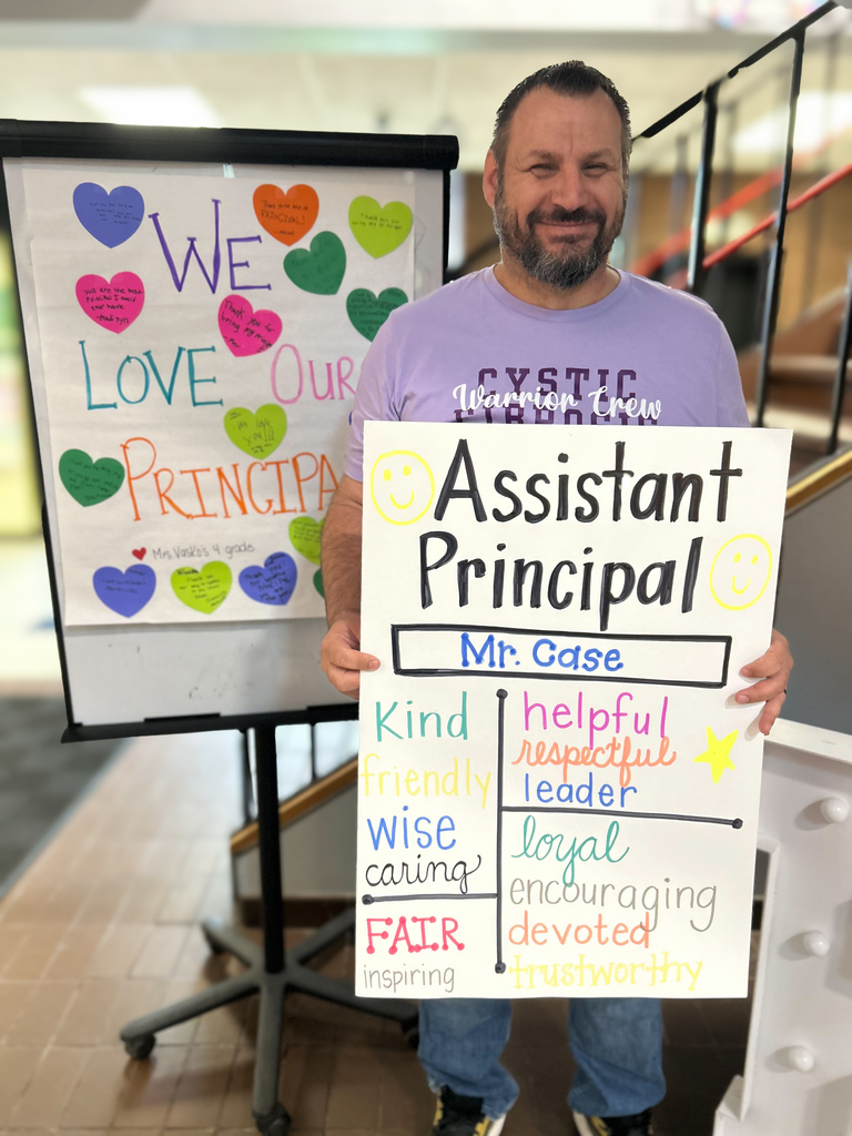 Mr. Case holding a poster