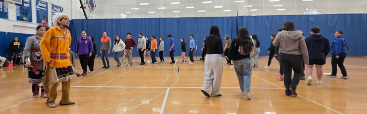 Students walking in gym space