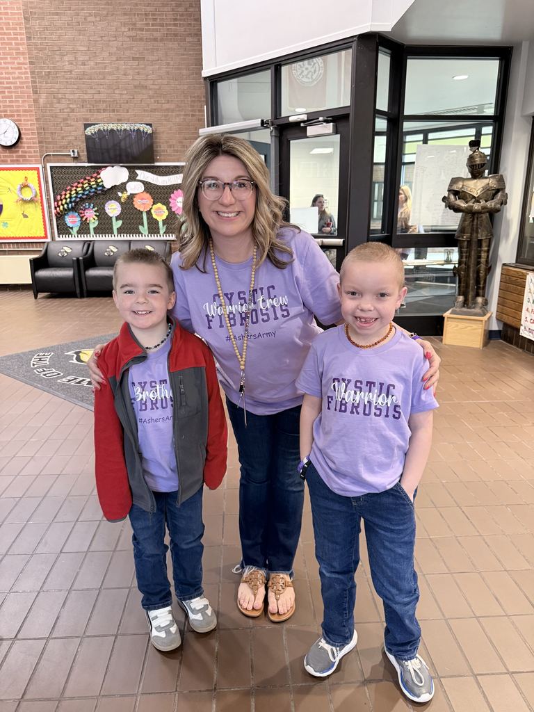 The principal and two students wear purple Cystic Fibrosis T-shirts. 