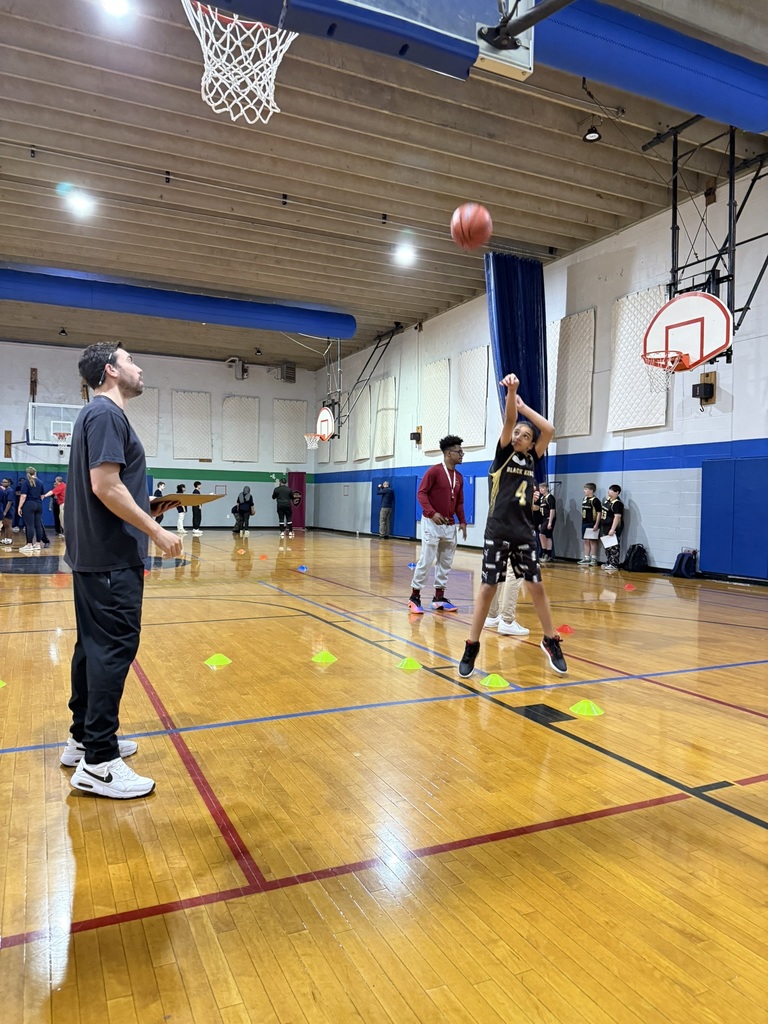A student makes a shot at the hoop. 