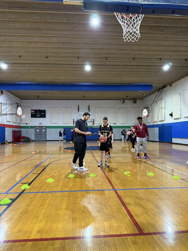 A student practices a free throw. 