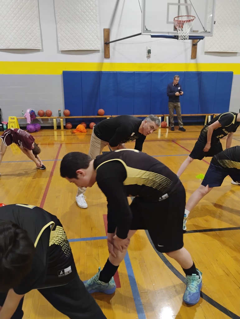 Students stretch with Mr. Prevett. 
