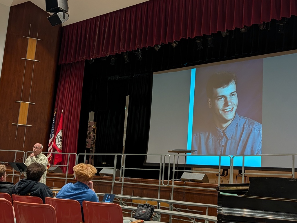 Mr. Brown speaks with Photo of Jeffrey behind him on screen