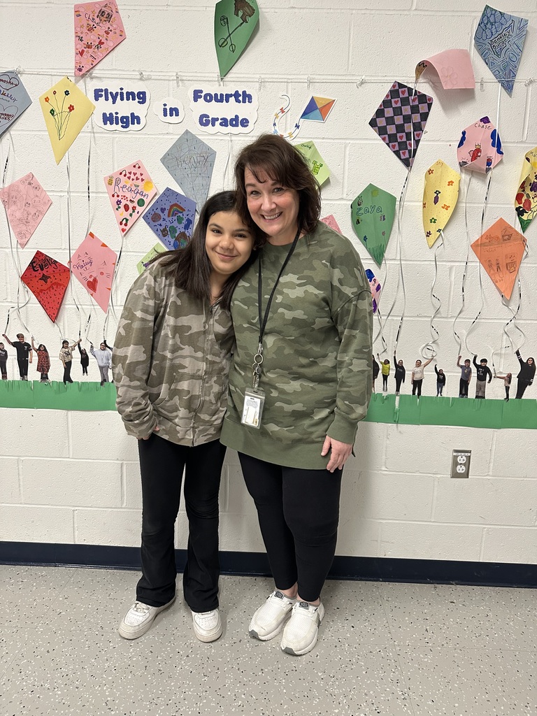 Mrs. Zbytek and student in camo sweatshirts