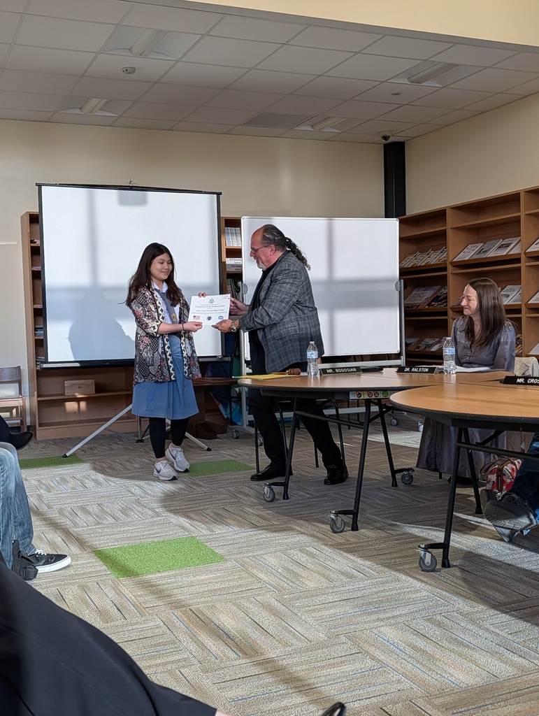 Mr. Bogosian receives the certificate from Elisabeth
