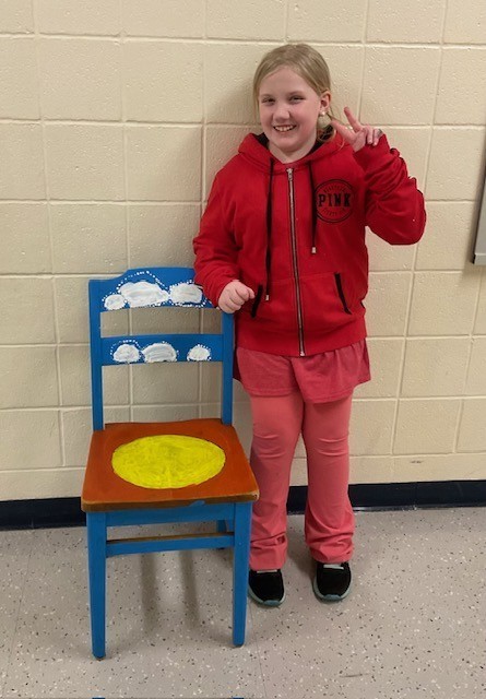 female student posing with a chair