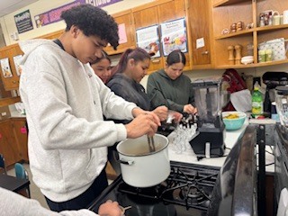 Students in a kitchen preparing food