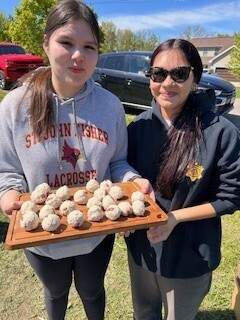 girls holding trays of dumplings