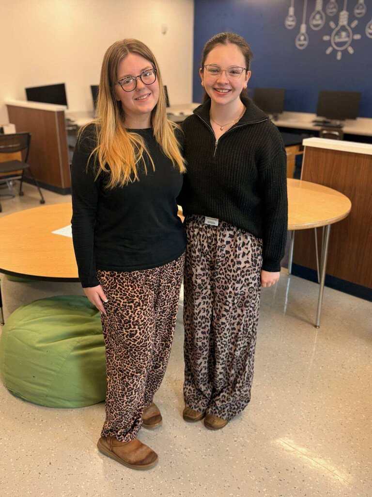 Students in black tops and leopard print bottoms