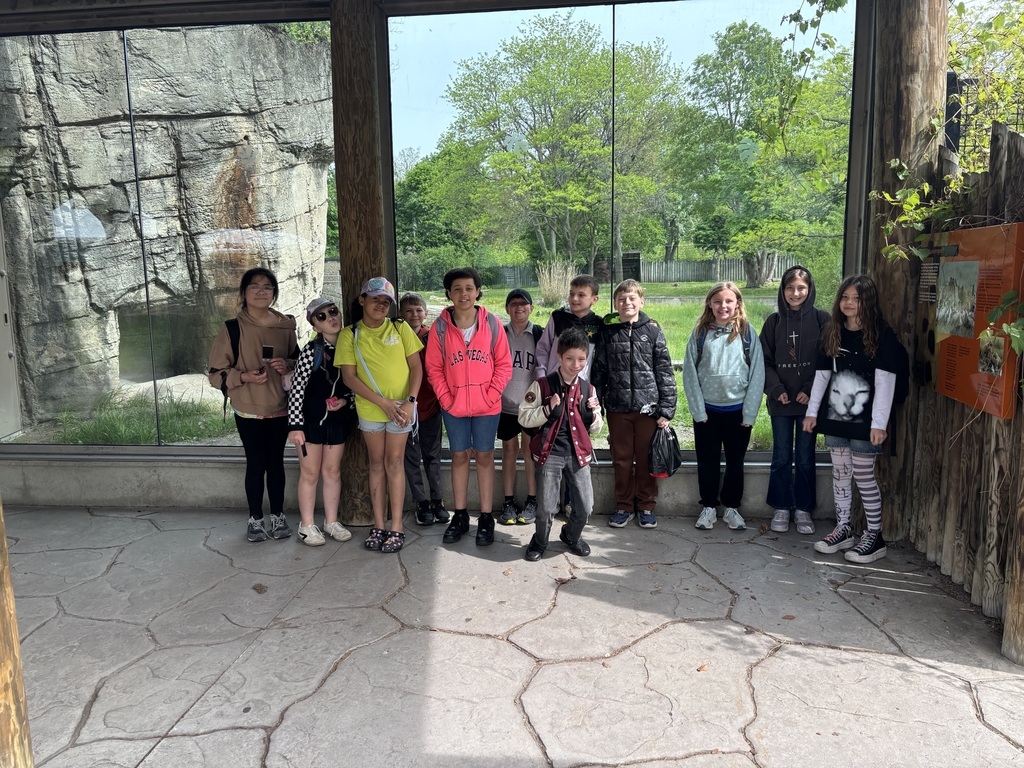 students in front of animal exhibit