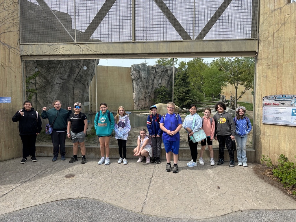 students pose in front of polar bear