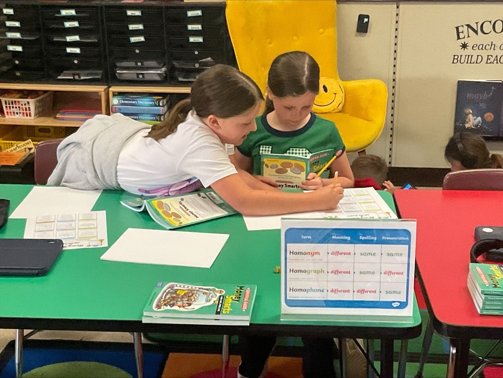 students working on money worksheets