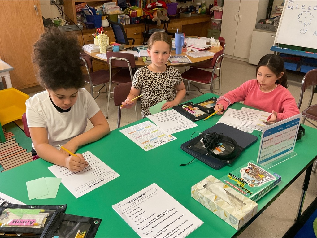 students working on money worksheets