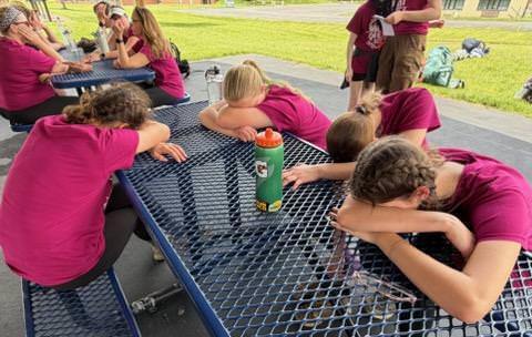 tired students resting heads on tables