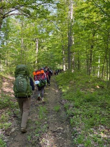 hiking up trail in woods