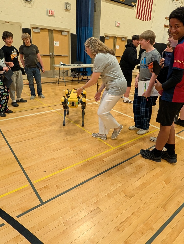 Students looking at robot dog
