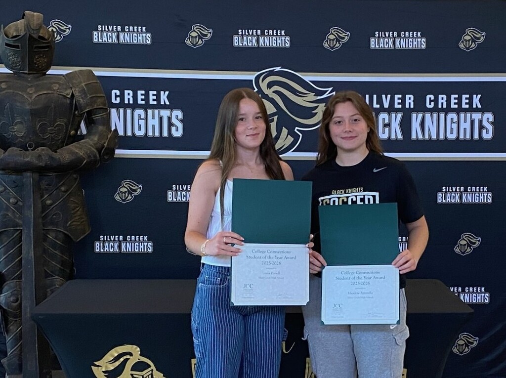 Liana & Meadow holding certificates