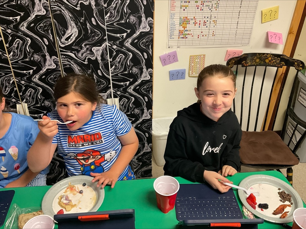students eat pancakes at the party. 