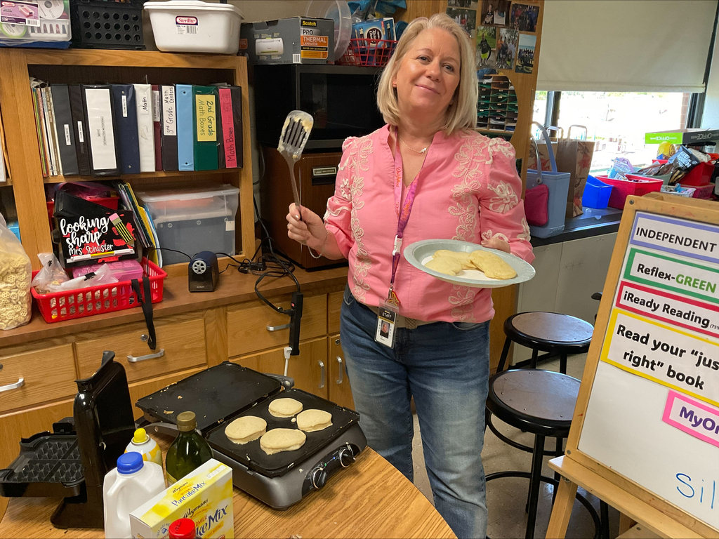 Teacher flips pancakes. 