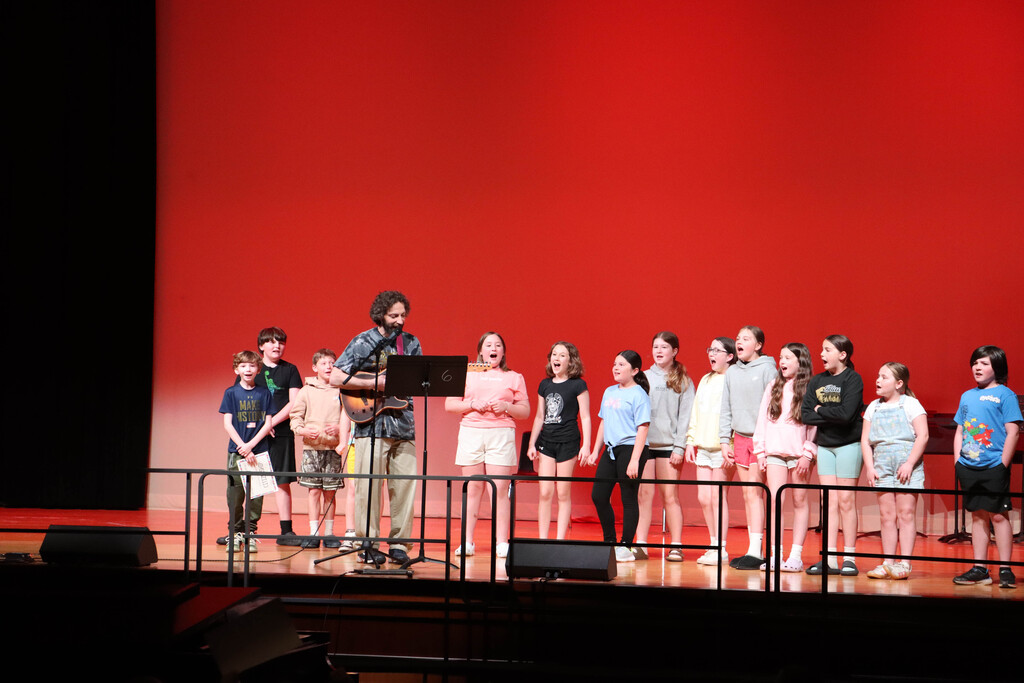 Mr. Cooper and class on stage. 