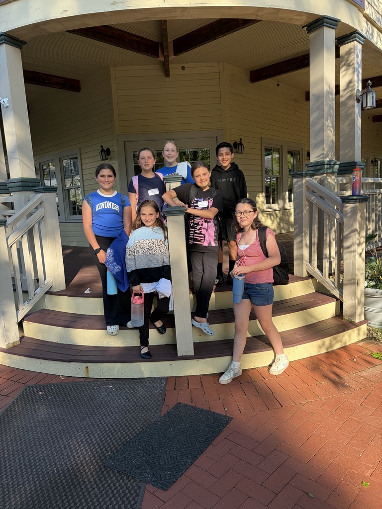 students smiling on staircase