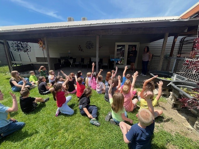 Students raise their hands.
