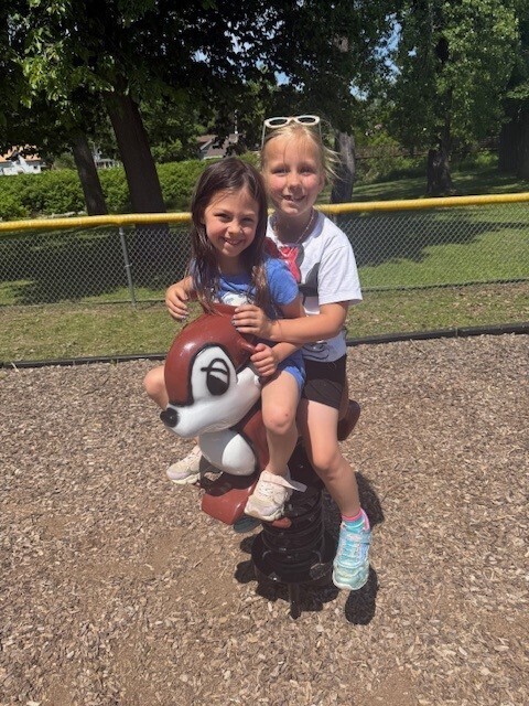 Two students play on the playground.
