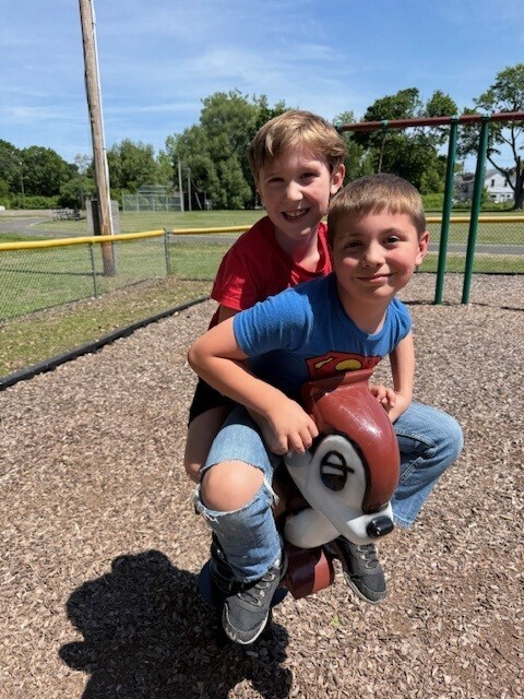 Two students play on the playground.