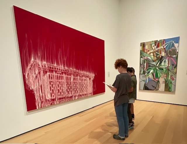 Students with a big painting. 