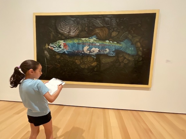 Student with a fish painting. 