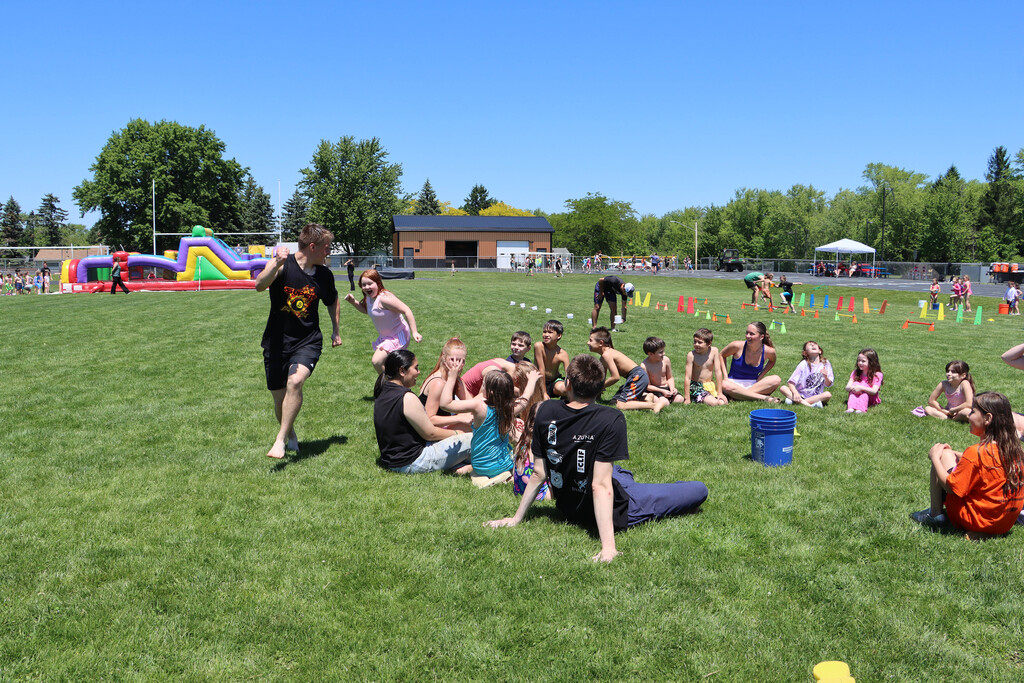 Students play water duck duck goose. 