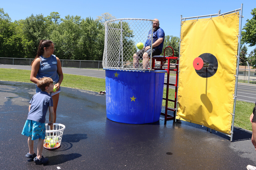Student throws at the target for the dunk tank. 