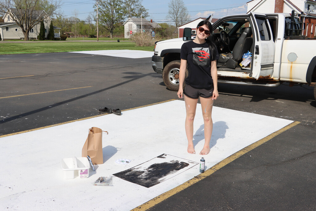 Senior paints parking spot.