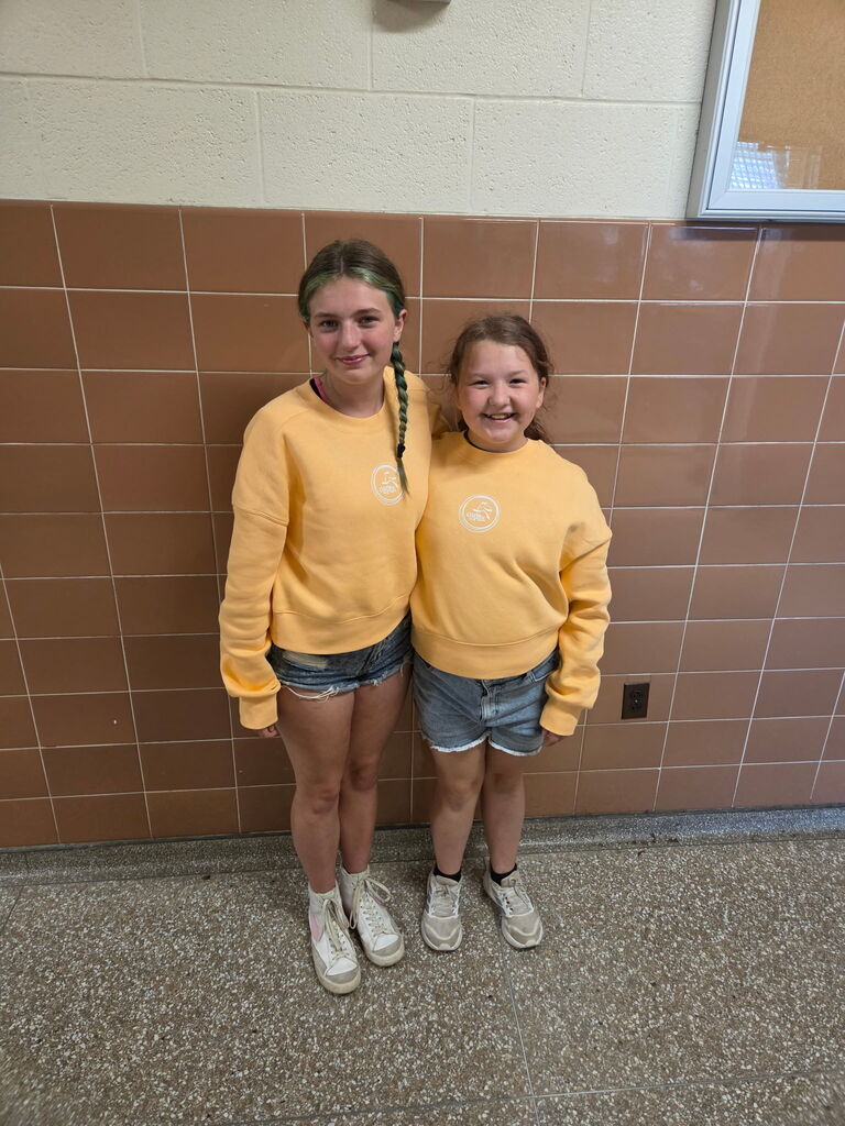 girls inyellow sweatshirts and denim shorts