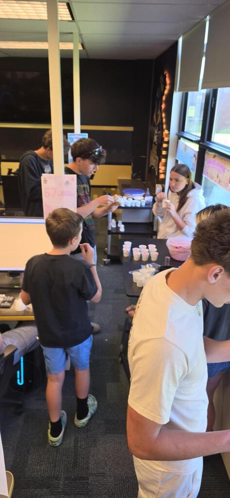students sampling ice cream in classroom