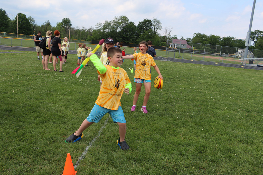 Student throws foam javelin. 
