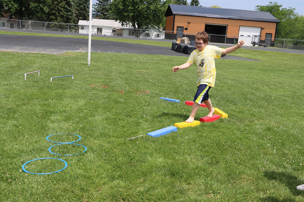 A student walks an obstacle course. 