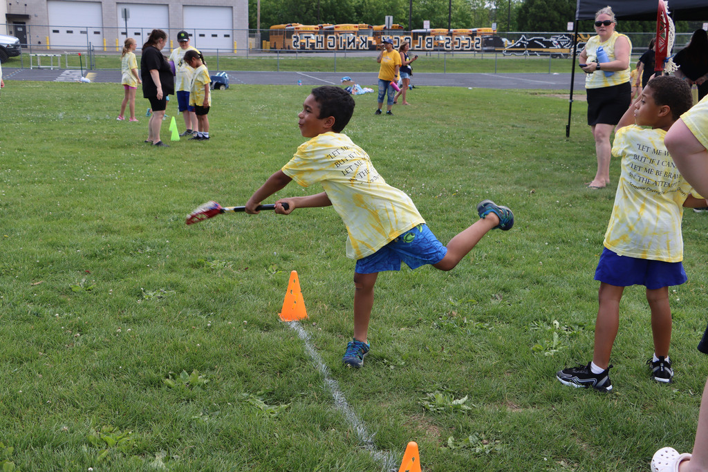 Student uses lacrosse stick. 