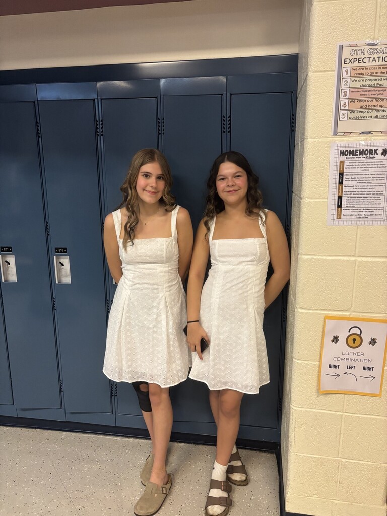 two middle school girls in white dresses