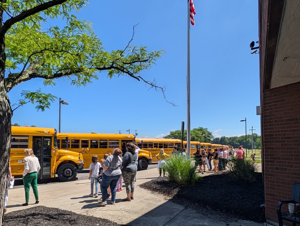 Staff waving to buses